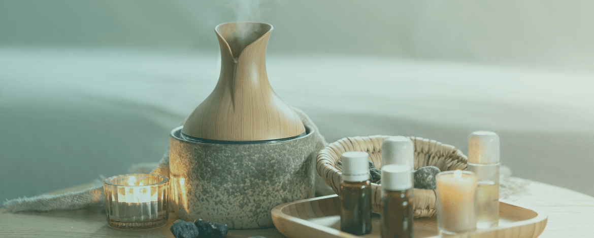 Collection of organic essential oils and diffuser used for clinical aromatherapy sessions.