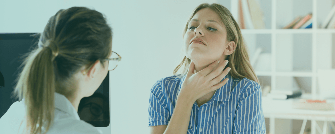 Woman checking her neck for thyroid swelling, representing natural thyroid health awareness.
